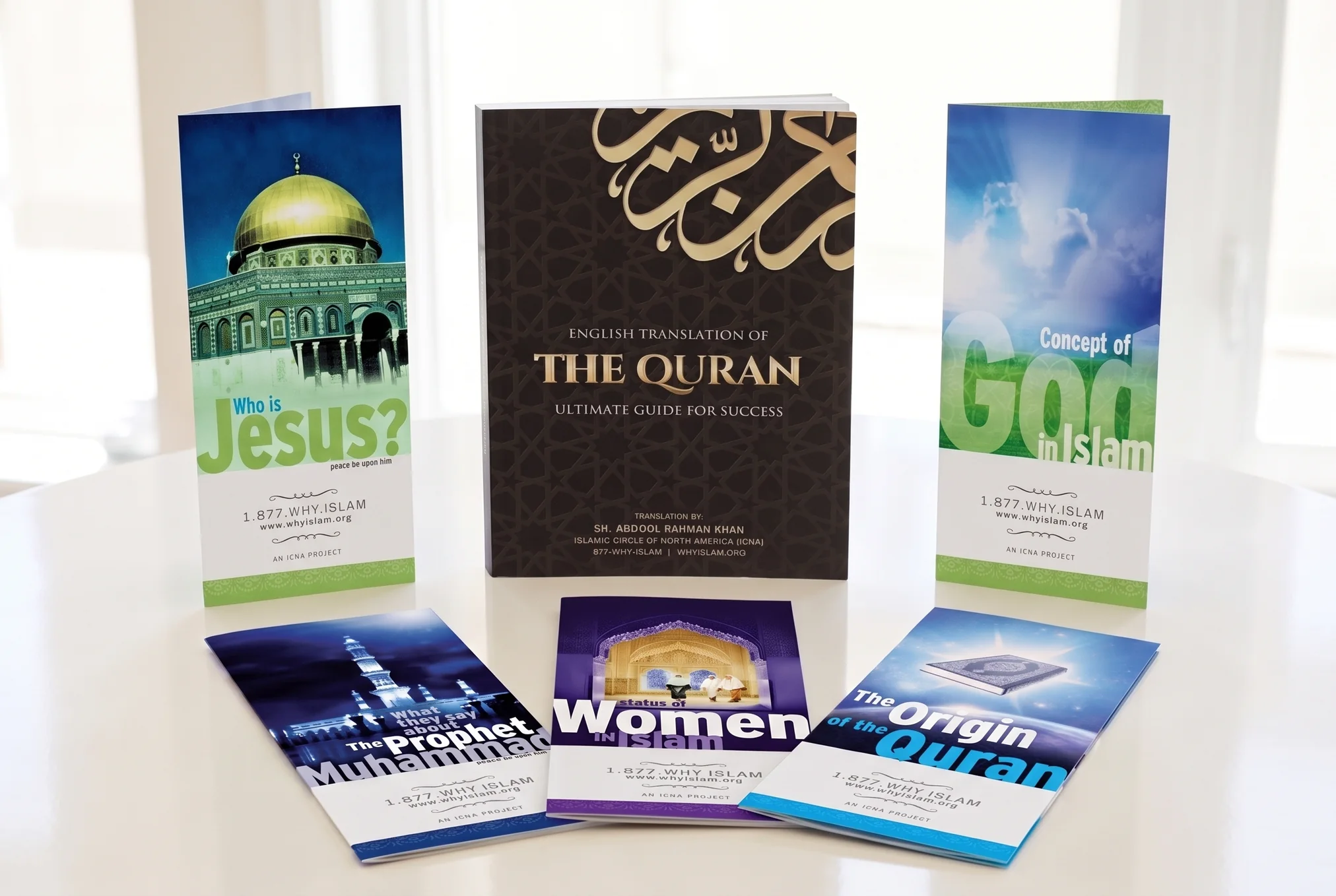 A free English Quran and five learning brochures, arranged on a table